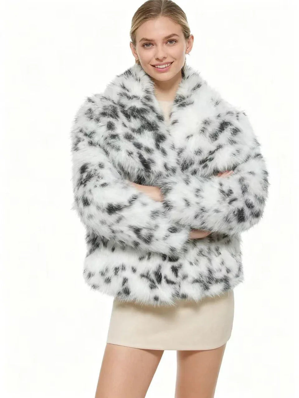Woman smiling in a faux fur leopard print jacket