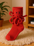 Red crew socks with a red knitted octopus appliqué on the cuff