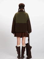 Back view of a woman wearing a color-block fleece jacket