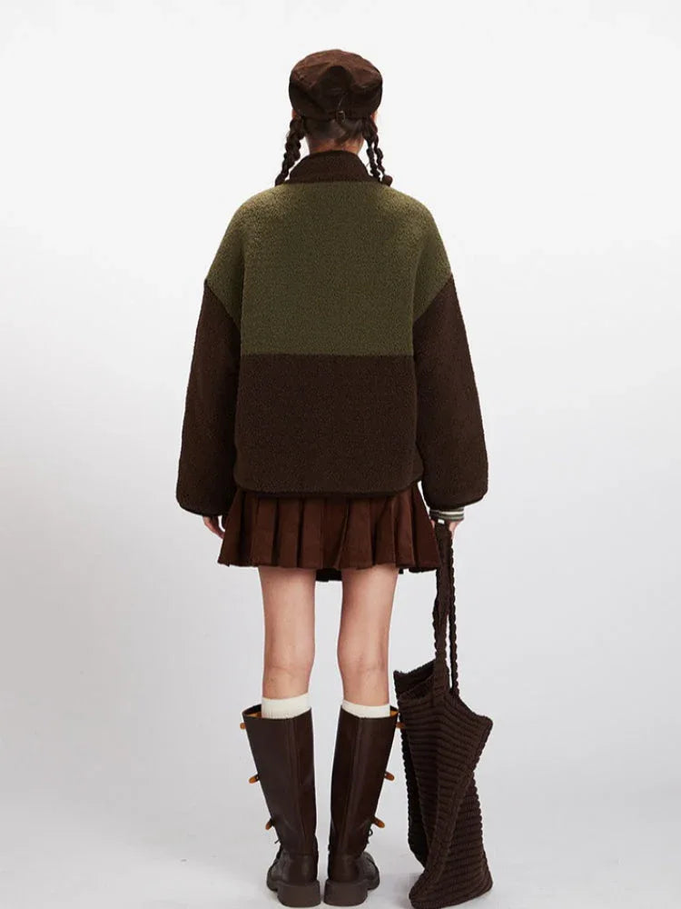 Back view of a woman wearing a color-block fleece jacket