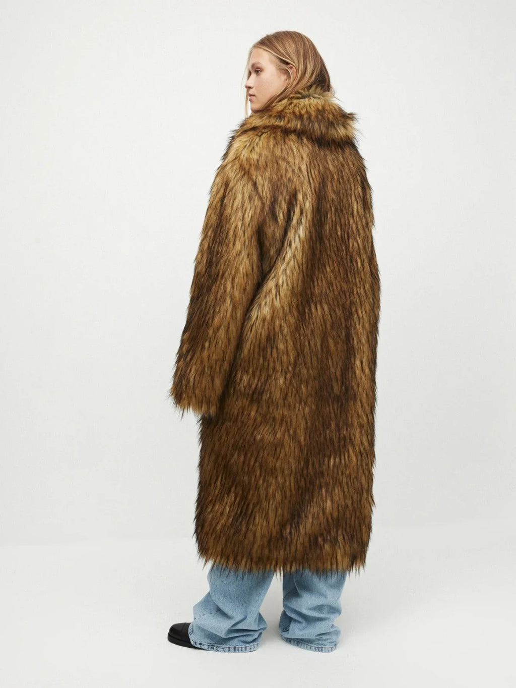 Back view of a woman in a long brown faux fur coat.