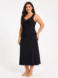Full-length shot of a woman wearing a black V-neck nightgown