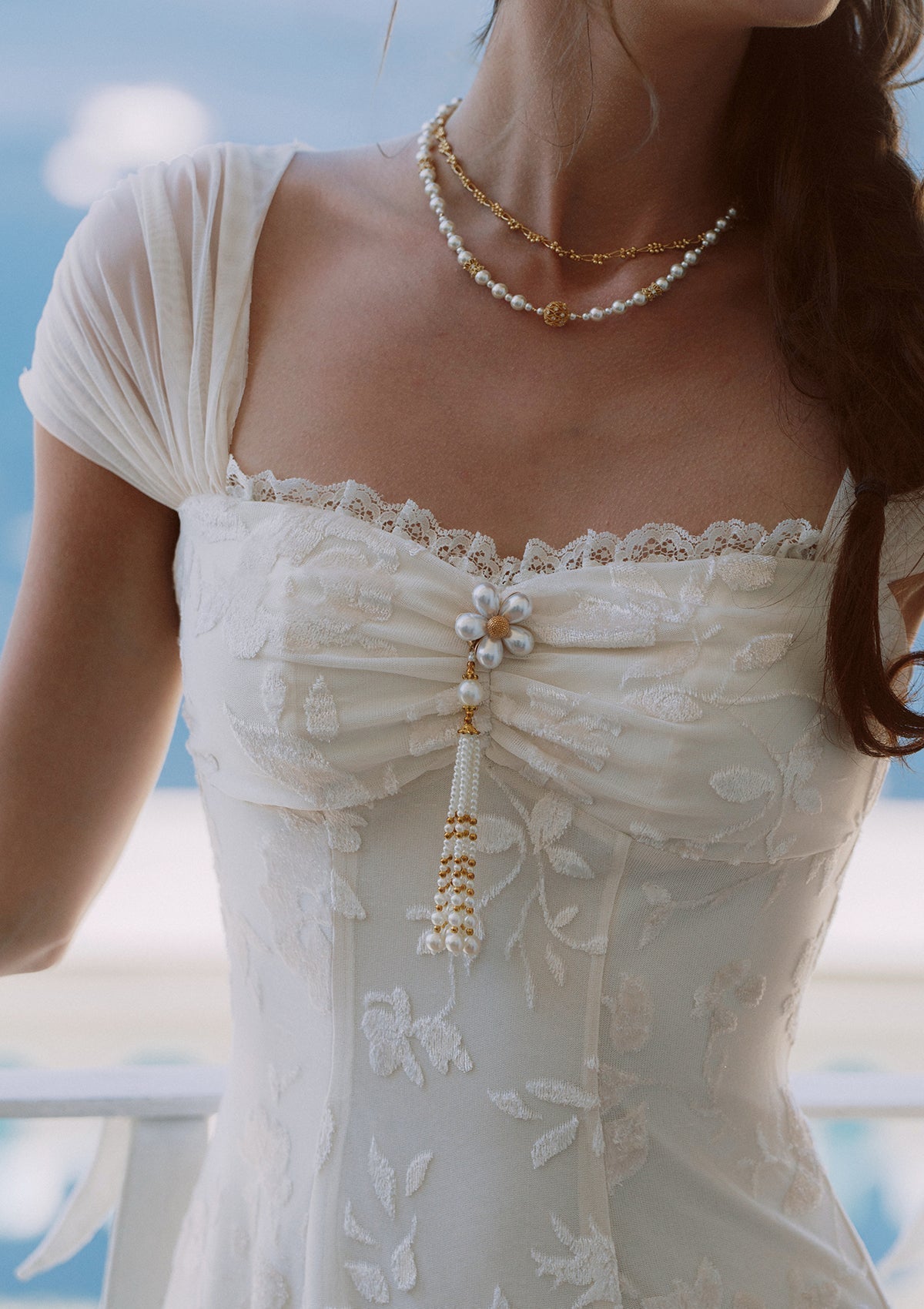 Full length view of a cream-colored jacquard midi dress with subtle floral pattern.