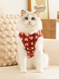 Ragdoll cat wearing a red and white checkered fleece pet vest with a white collar