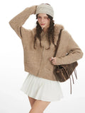 Close-up of woman posing in beige faux fur hooded cardigan jacket