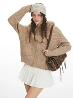 Close-up of woman posing in beige faux fur hooded cardigan jacket