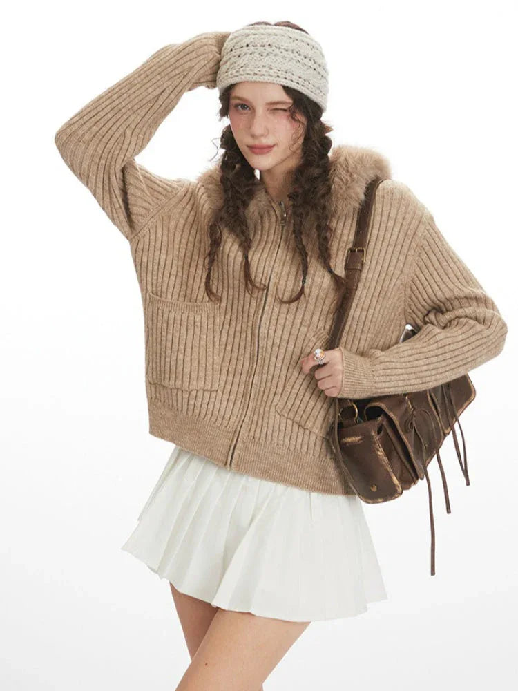 Close-up of woman posing in beige faux fur hooded cardigan jacket