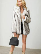 Full body shot of a woman in a faux fur coat with a handbag