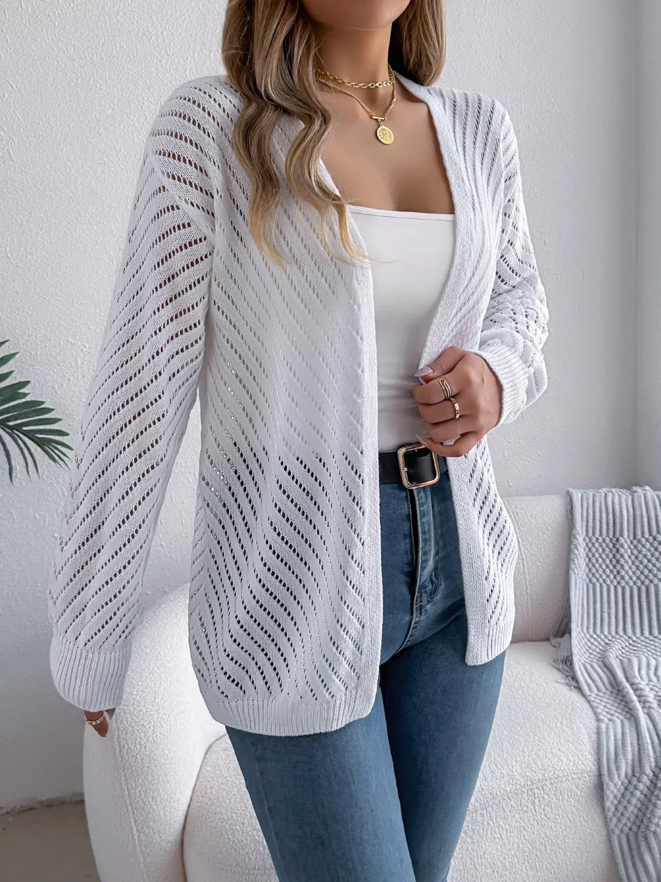 Front detail of a white lightweight knit cardigan