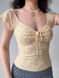Yellow floral print mesh top with drawstring tie and flutter sleeves
