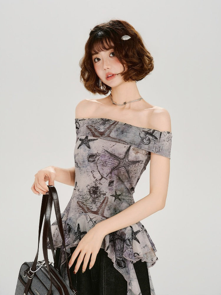 Woman wearing a grey off-the-shoulder top with a nautical print