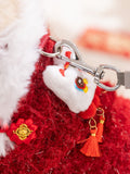 Detail of the vest showing the embroidered lion head applique, red tassels, and metal clasp for a leash.