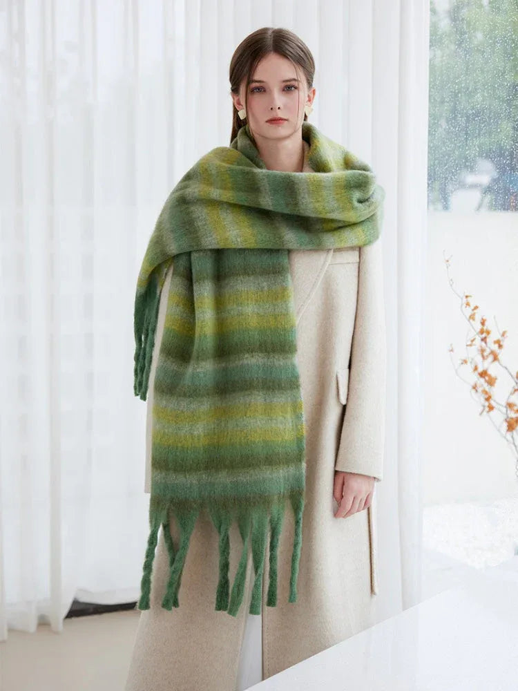 Model showcasing a large, soft green striped scarf with tassels