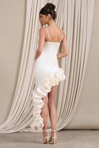 Rear view of a cream satin bodycon dress with spaghetti straps and a cascading ruffle detail on the side.