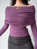 Close-up of a purple off-the-shoulder ribbed knit top with a draped neckline.