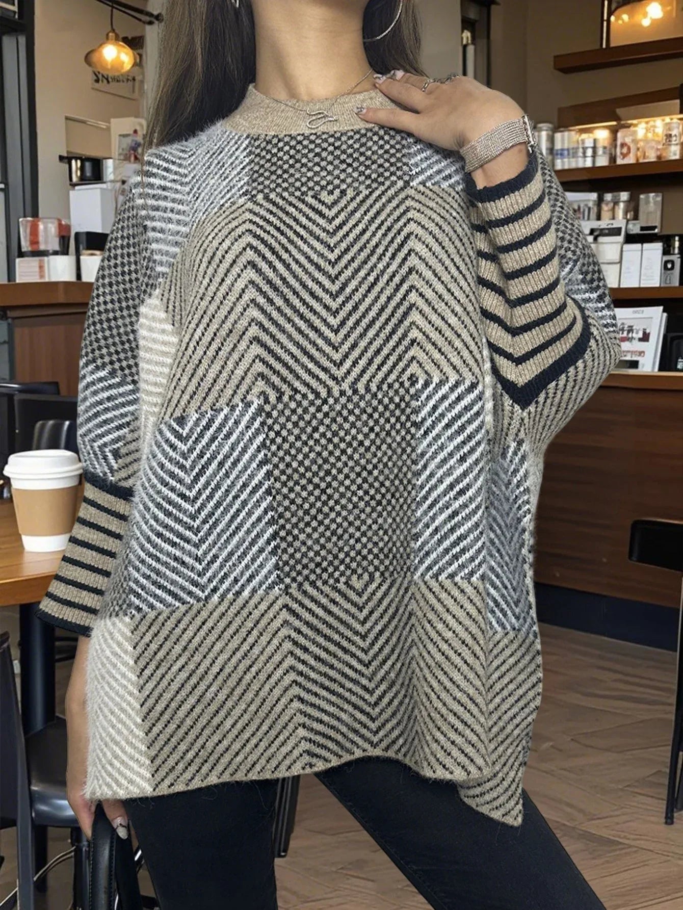 Detail of the crew neckline and relaxed fit of the poncho