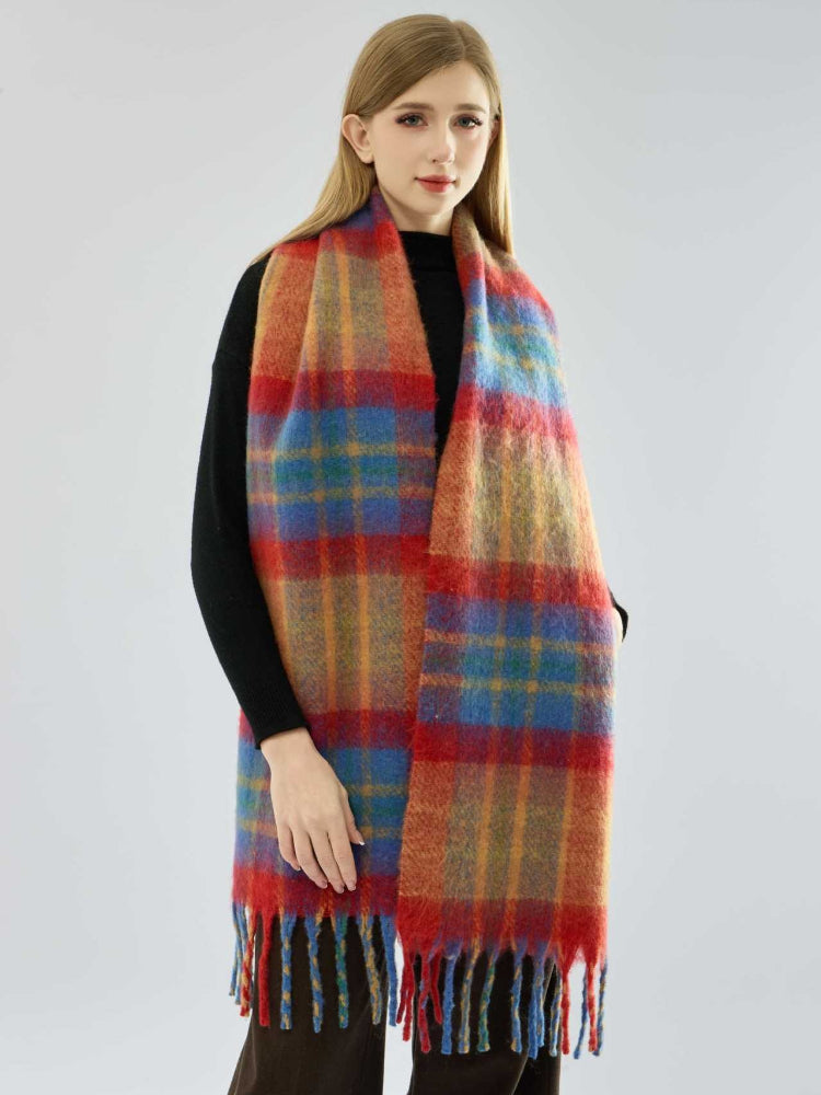 Woman wearing a colorful plaid scarf with fringe