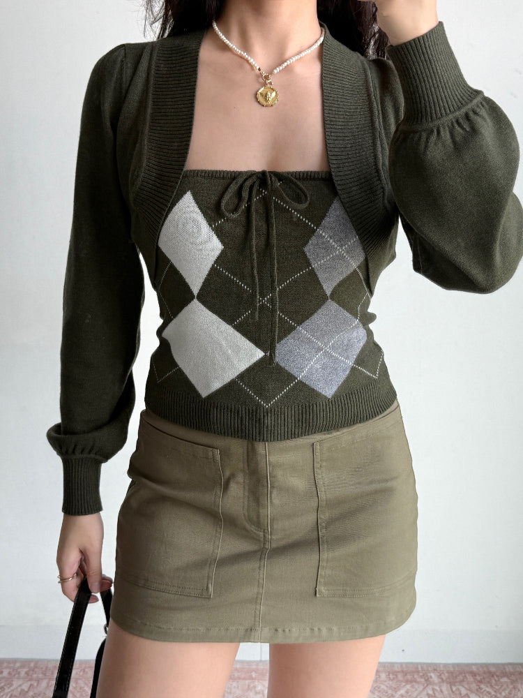 Full outfit view showing the dark green argyle knit set paired with khaki cargo skirt.