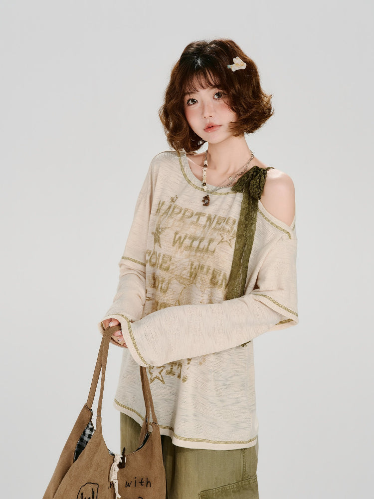 Full body shot of a woman in a cream-colored long-sleeved graphic t-shirt and olive green cargo pants.