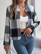 Front view of a woman wearing a blue and white plaid jacket.