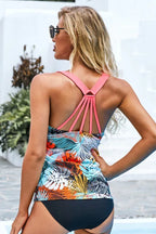 Rear view of a woman in a tropical print tankini showing the racerback strap detail