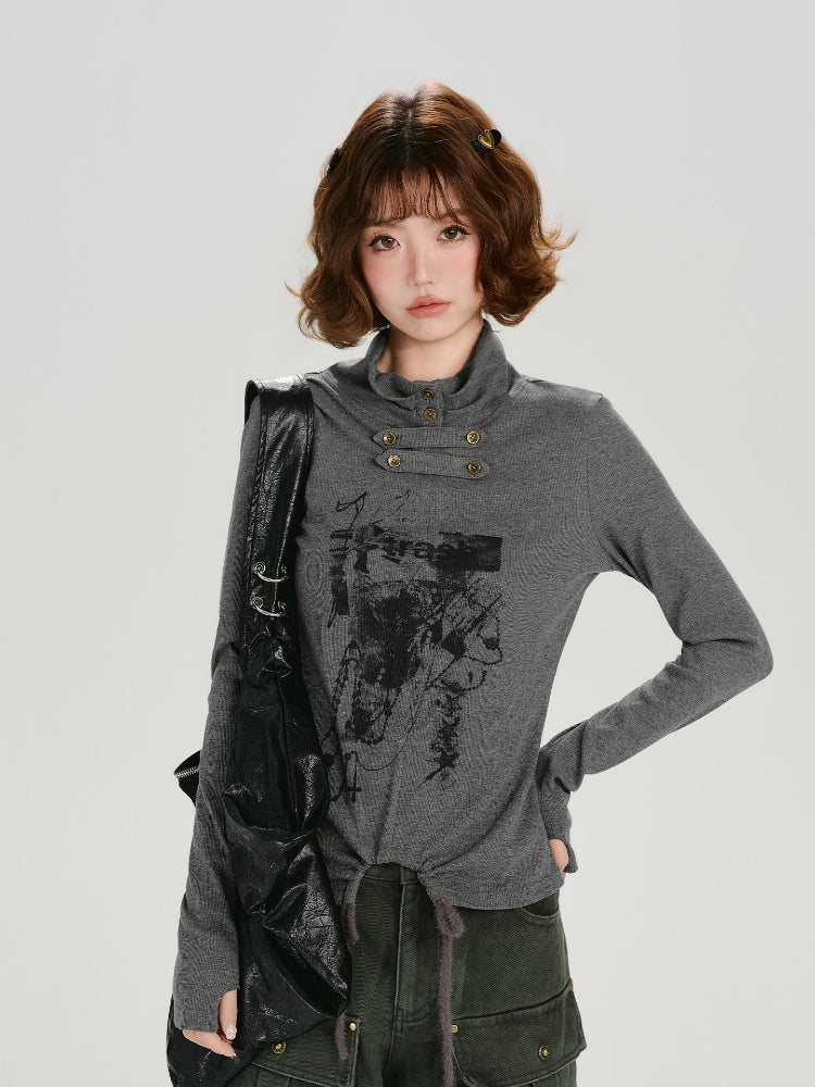 Close-up of the grey long-sleeve graphic print turtleneck top showcasing button detail