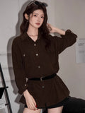 Full-body shot of a woman in a brown corduroy oversized shirt, showcasing the silhouette.