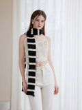 Close-up of a long striped scarf with ruffle detail
