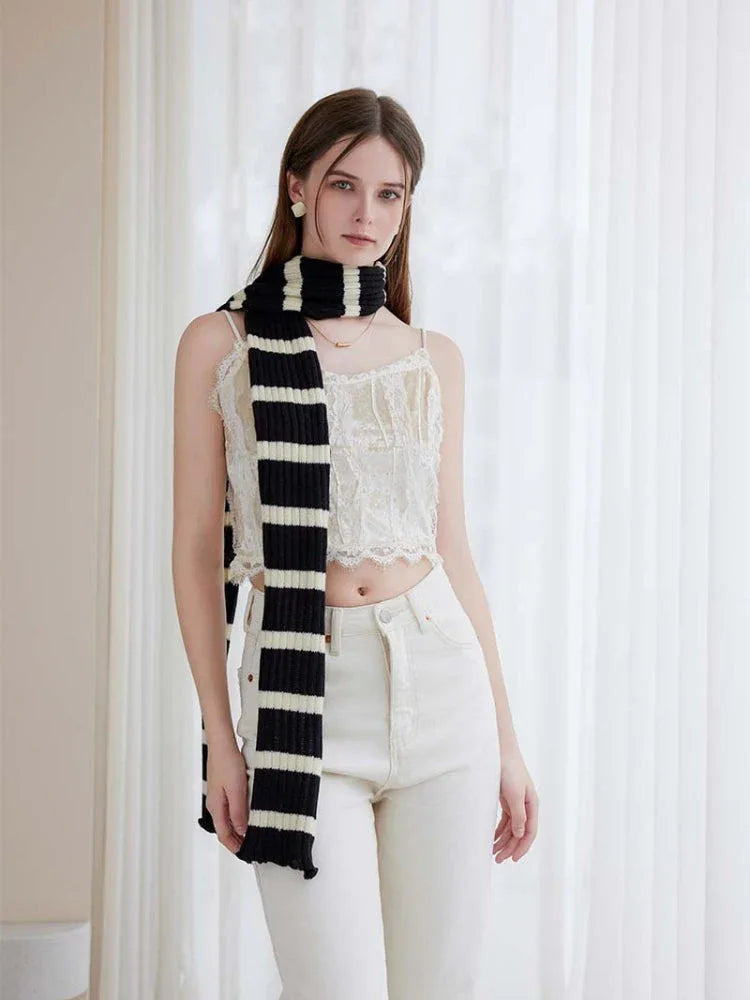 Close-up of a long striped scarf with ruffle detail