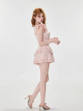 Side view of a woman in a pink tiered mini dress