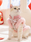 Cat sitting and looking up, wearing a pink traditional Chinese inspired pet vest with faux fur trim and floral embroidery.