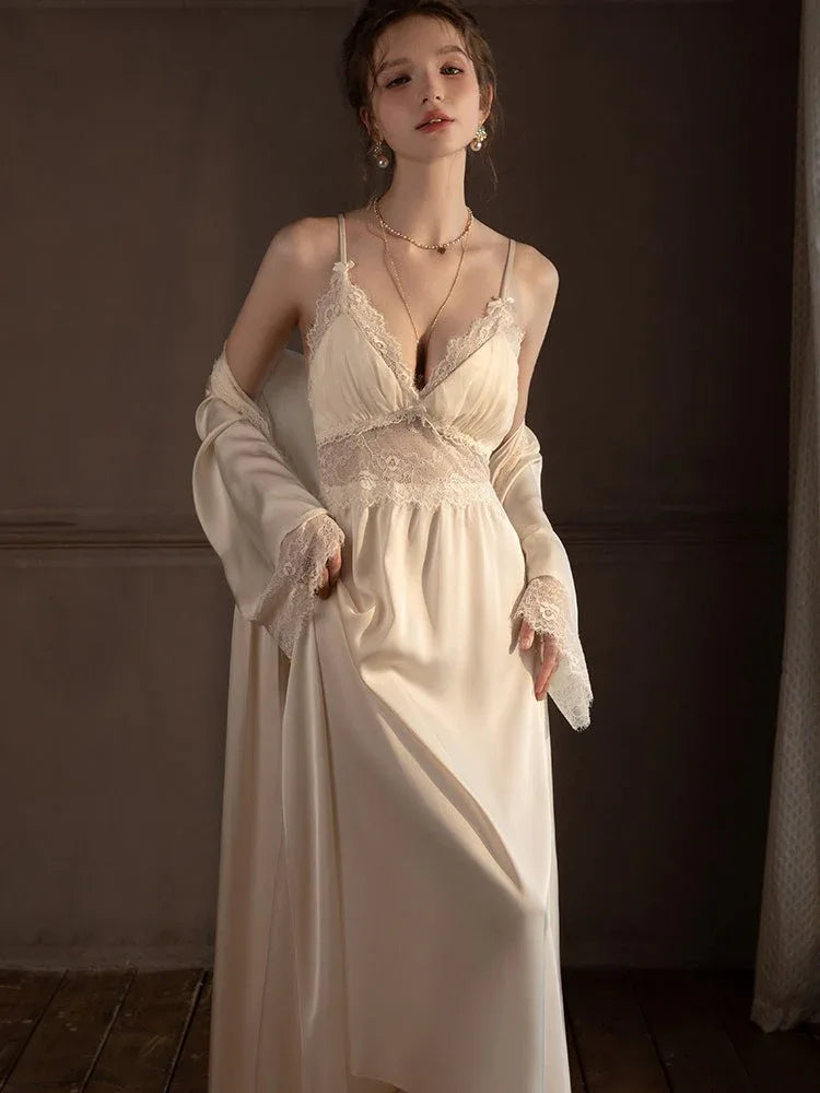 Woman posing in a cream-colored satin slip dress and robe set.