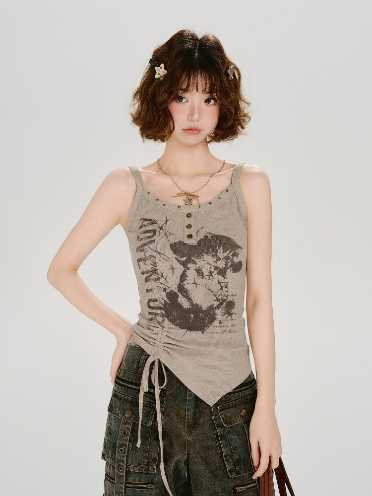 Woman with short brown hair wearing a taupe ribbed knit graphic print tank top and dark wash cargo pants