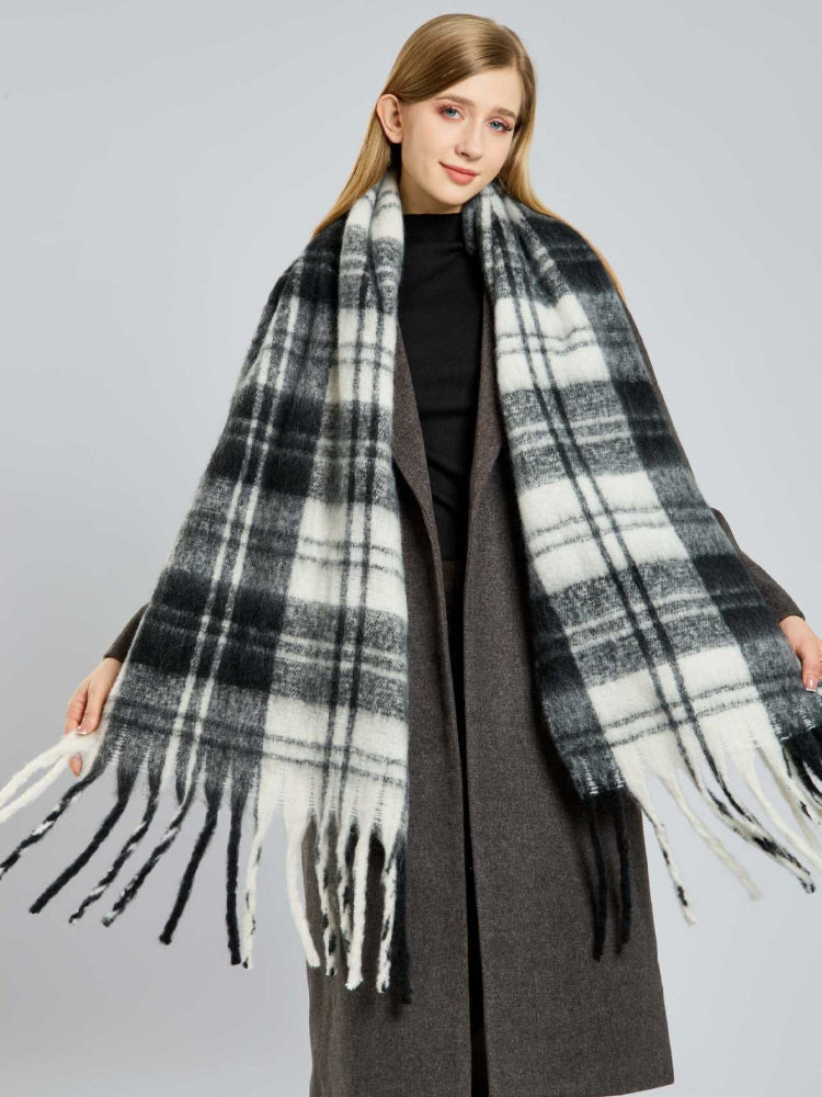 Woman models a thick, oversized plaid scarf