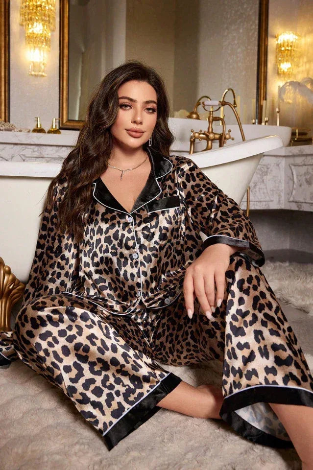 Rear view of a woman wearing a leopard print satin pajama set with contrasting trim.