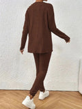 Rear view of a woman in a brown ribbed knit loungewear set with a crew neck top and slim-fit pants.