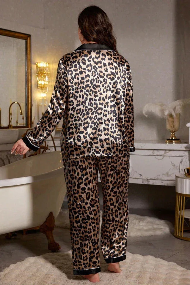 Woman modeling a leopard print satin pajama set with long sleeves and pants, showcasing the back view.