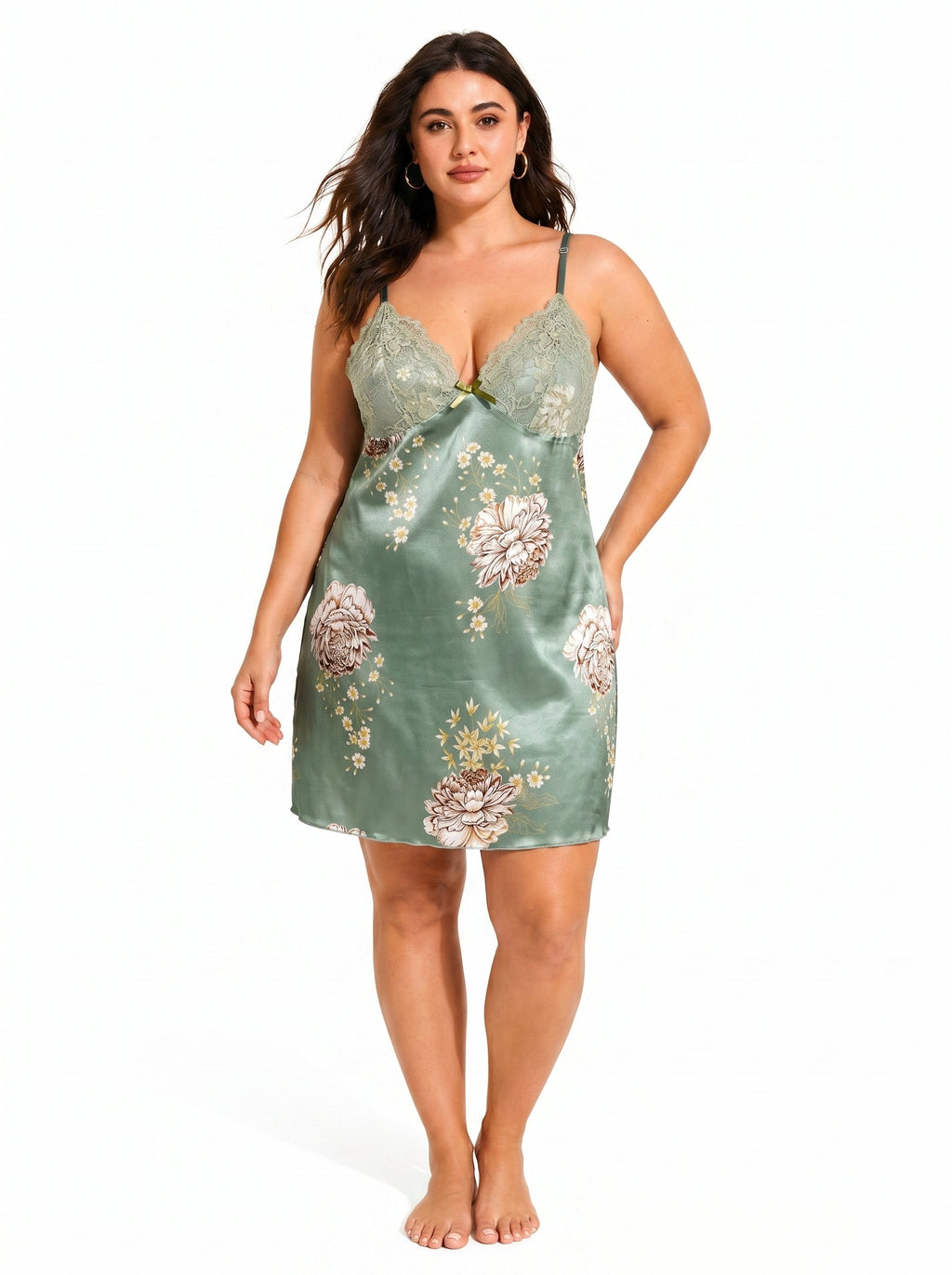 Plus-size woman modeling a green satin slip dress with lace trim and floral pattern