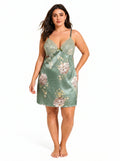 Plus-size woman modeling a green satin slip dress with lace trim and floral pattern
