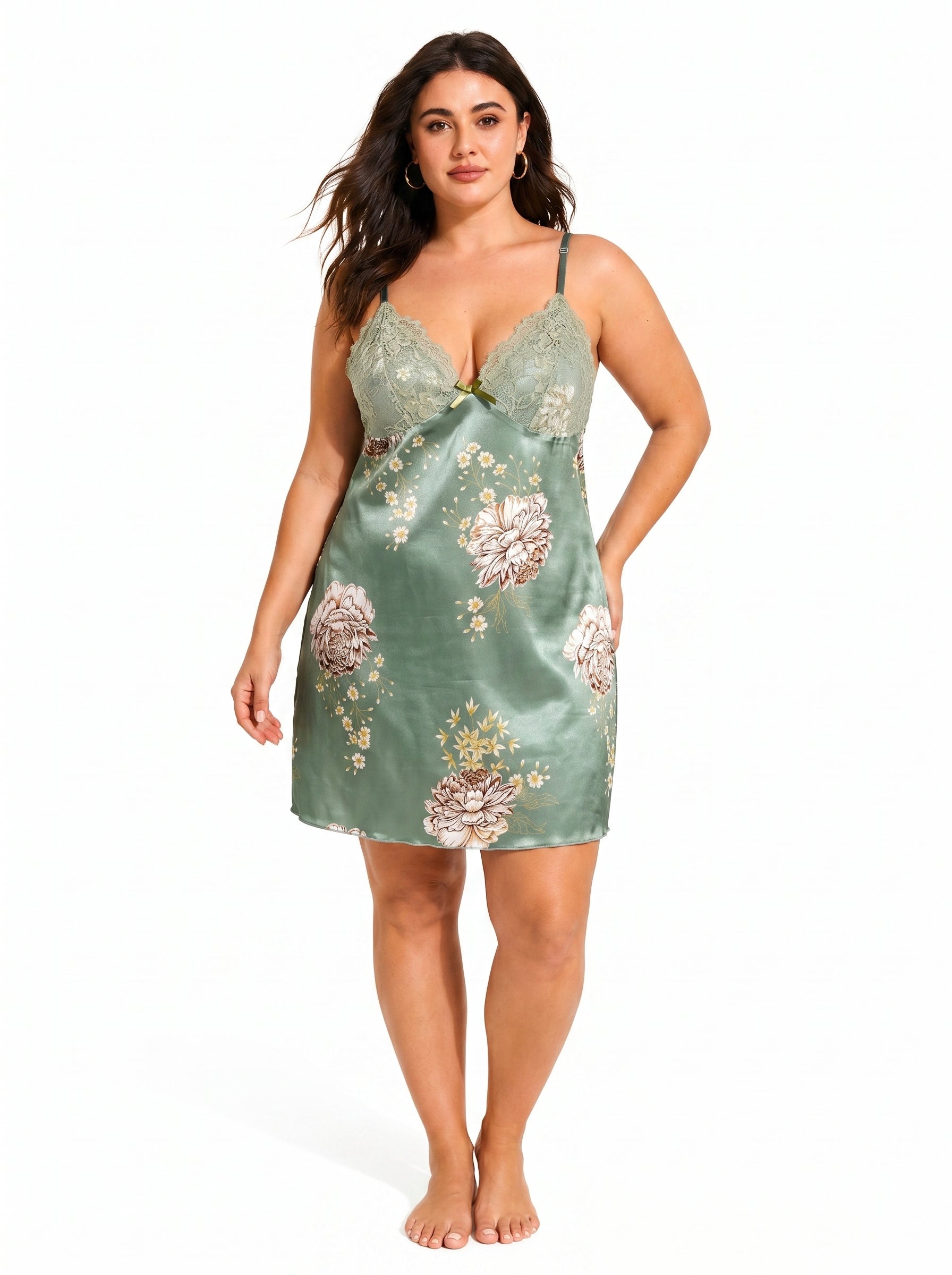 Plus-size woman modeling a green satin slip dress with lace trim and floral pattern