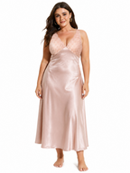 Full body shot of a plus size model showcasing a blush pink satin midi slip dress with lace accents.