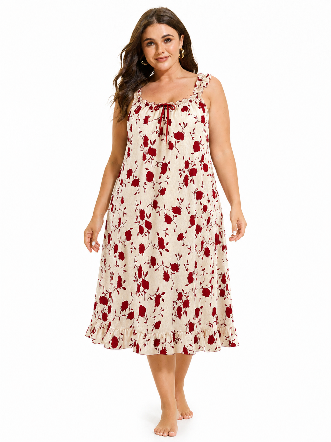 Front view of a woman in a cream and red floral print nightgown, smiling.