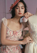 Close-up of a pink floral print fabric with intricate detailing.
