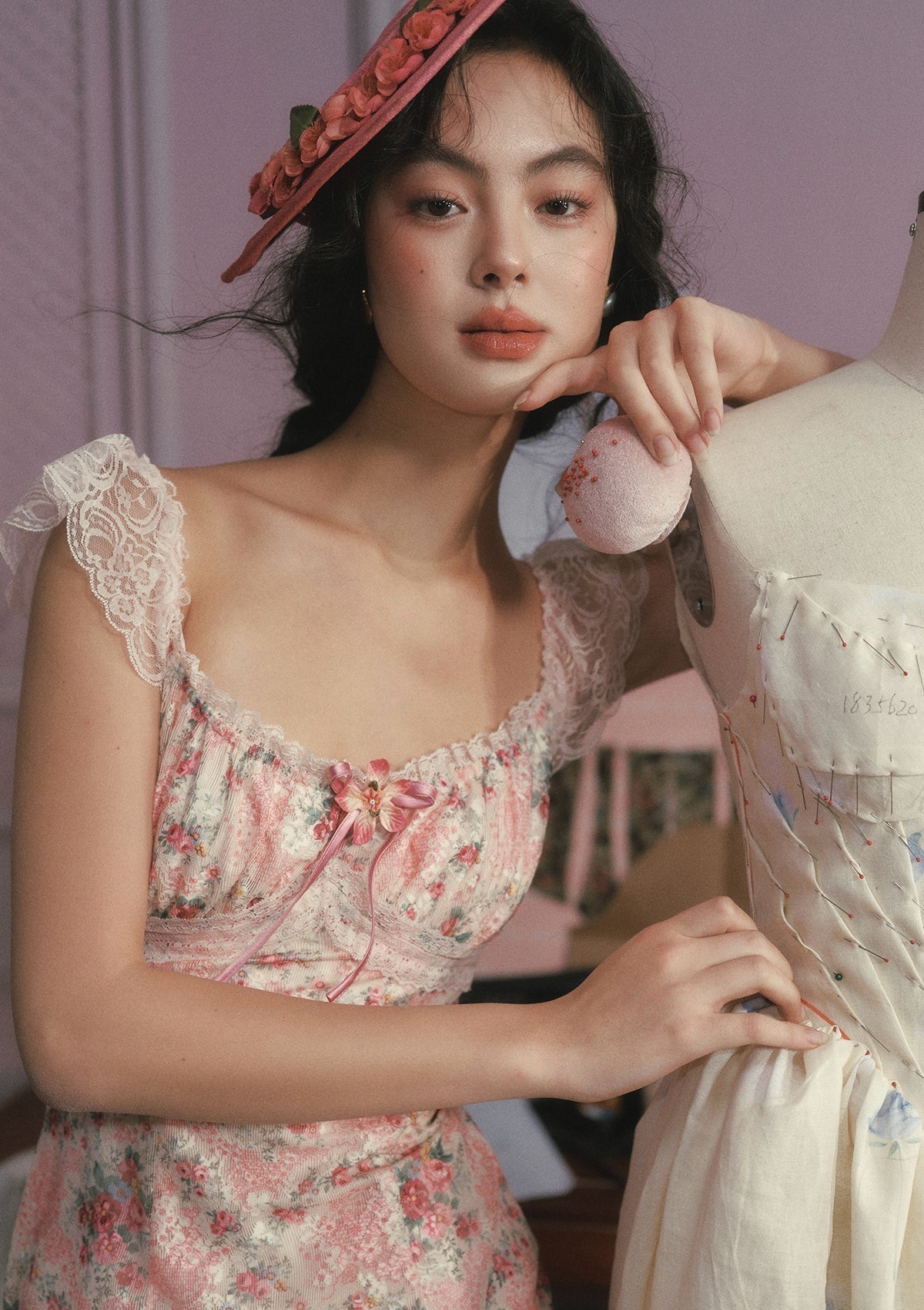 Close-up of a pink floral print fabric with intricate detailing.