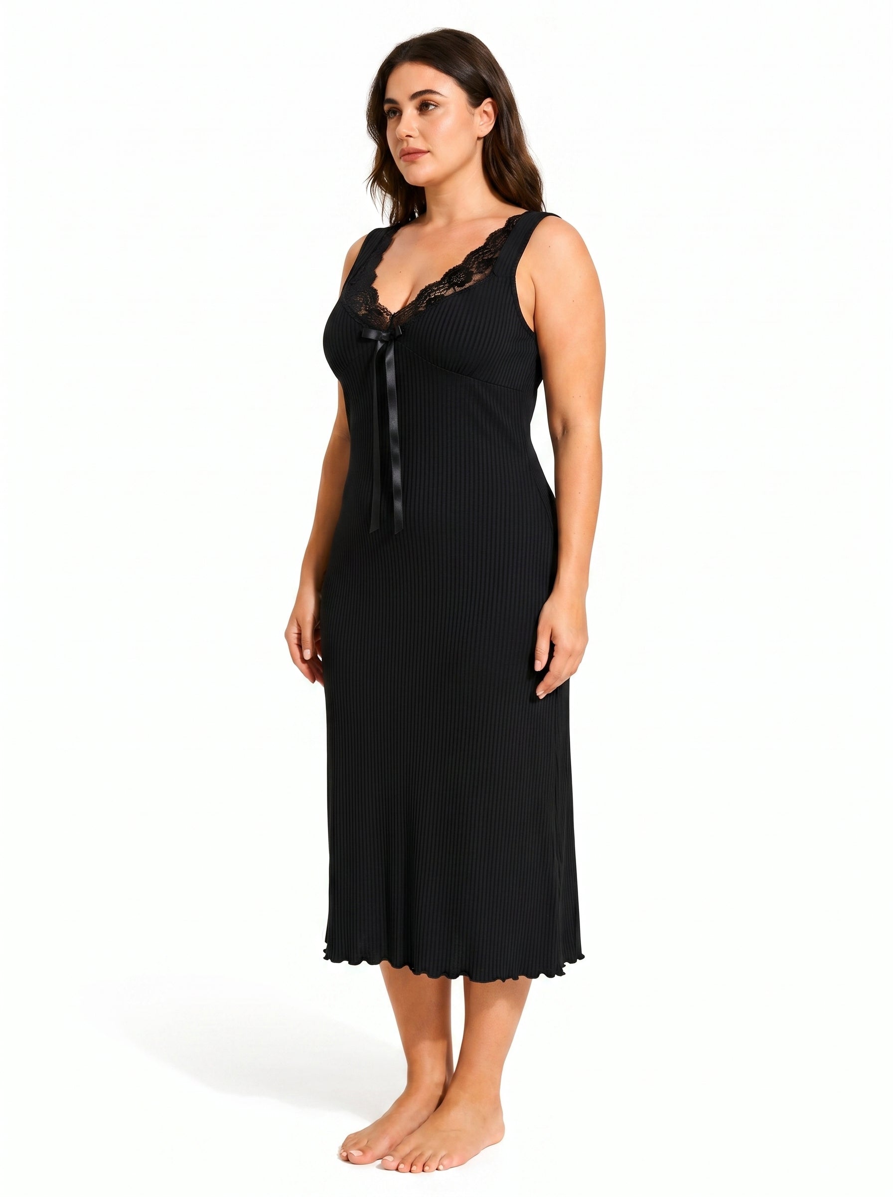 Side profile of a woman in a black ribbed knit nightgown with a scalloped hem