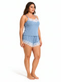 Side view of a woman wearing a light blue ribbed knit camisole and shorts set with white lace trim.