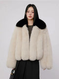 Cream faux fur jacket with black collar on model