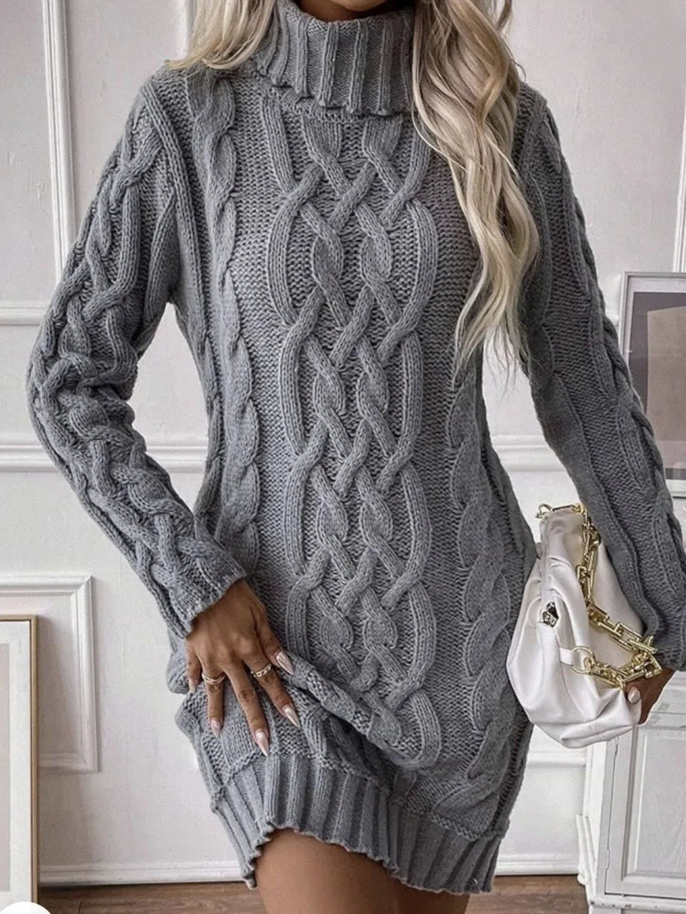 Grey cable knit turtleneck sweater dress styled with a white handbag
