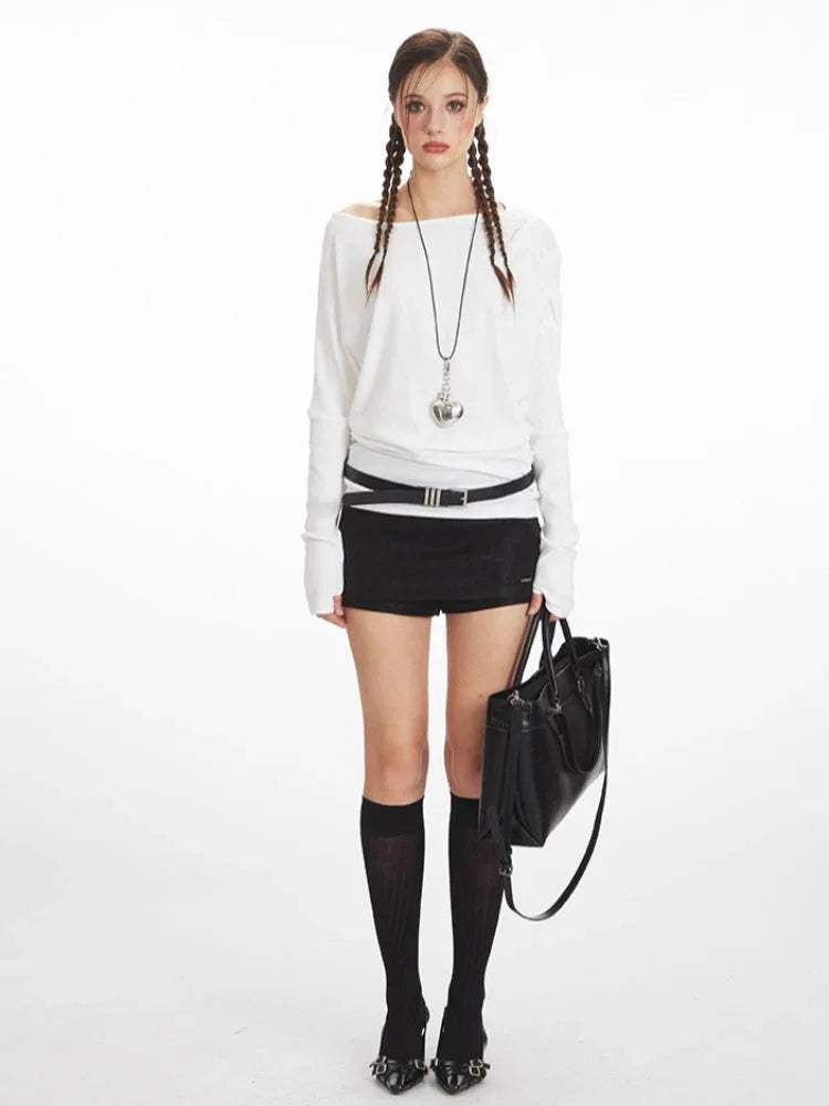 Model wearing a white long-sleeve top with a boat neckline and black shorts. Main image