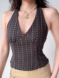 Close-up of a dark patterned halter top with a v-neckline.